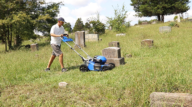 Grave Mowing in a Cemetery